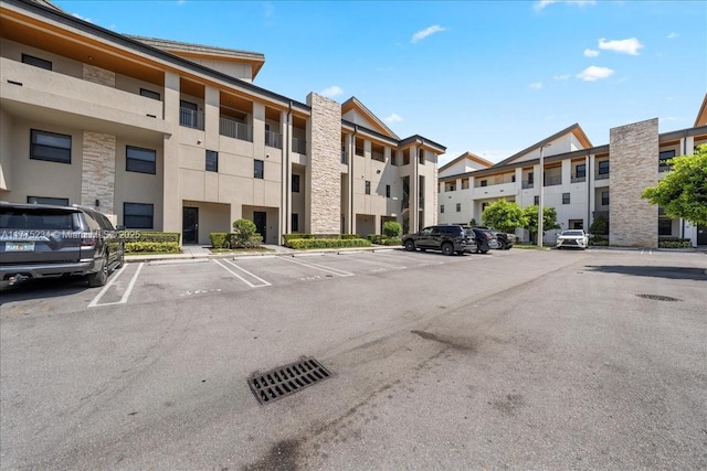 view of building exterior featuring uncovered parking