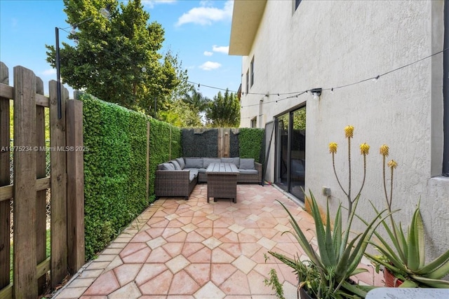 view of patio / terrace with a fenced backyard, a gate, and an outdoor living space