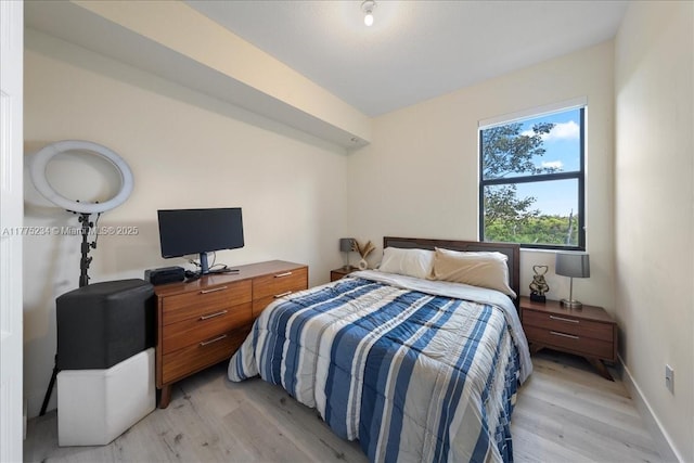 bedroom with baseboards and light wood-type flooring