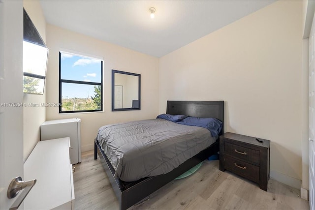 bedroom featuring baseboards and light wood-type flooring