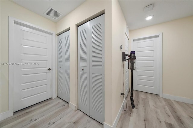hall with baseboards, recessed lighting, visible vents, and light wood-style floors