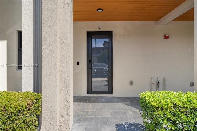 property entrance featuring stucco siding