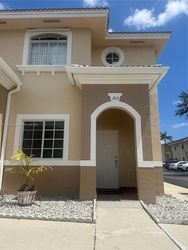 entrance to property featuring stucco siding
