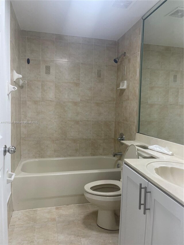 full bathroom with tile patterned floors, toilet, shower / bathtub combination, and vanity