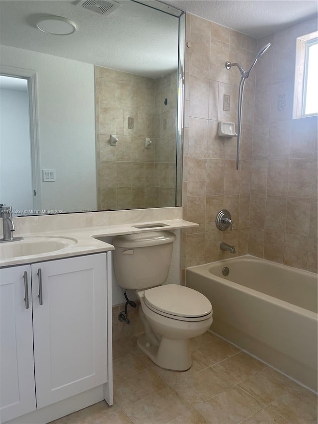 full bath featuring visible vents, shower / bathtub combination, toilet, vanity, and tile patterned flooring