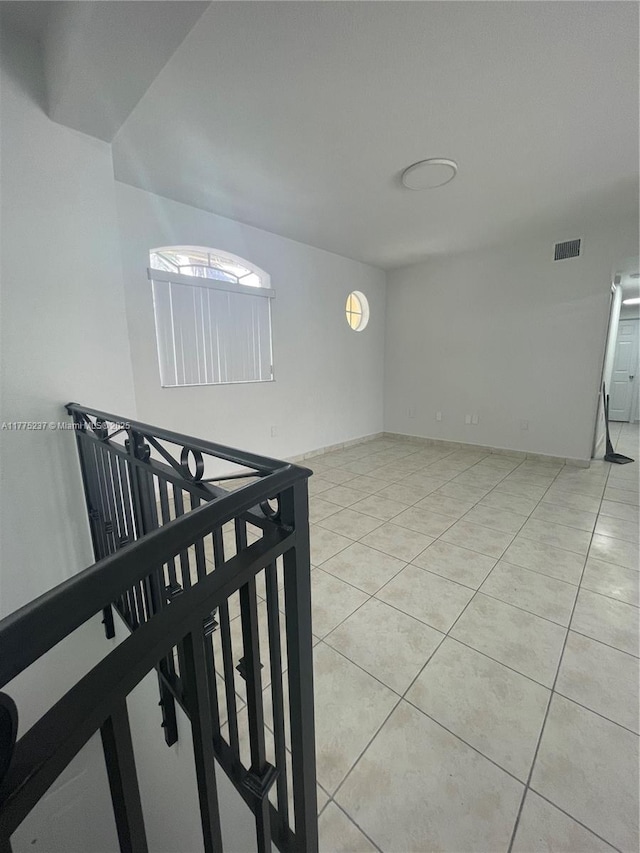 empty room with visible vents and light tile patterned floors