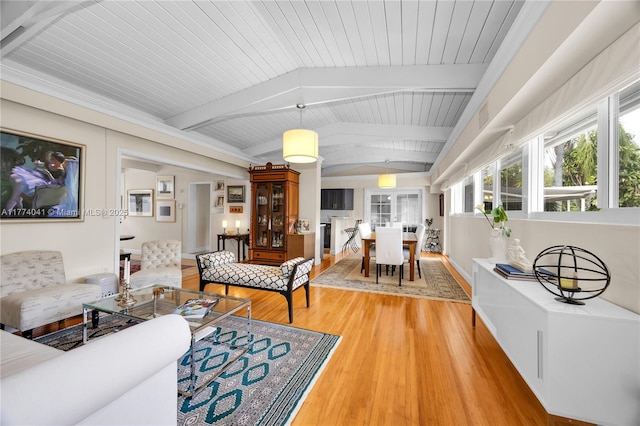 living area featuring lofted ceiling with beams, wooden ceiling, and light wood-type flooring