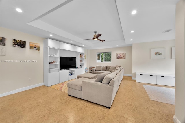 living room featuring ceiling fan, visible vents, recessed lighting, and a raised ceiling
