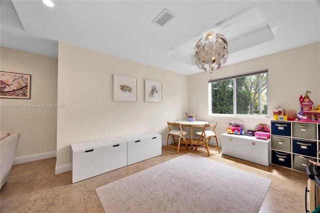 playroom featuring baseboards, visible vents, and a raised ceiling