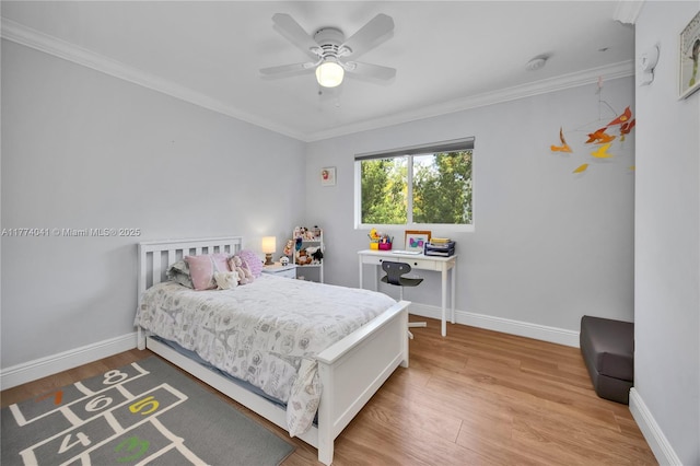bedroom with ornamental molding, baseboards, and light wood-type flooring