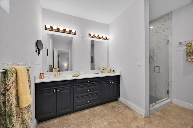 bathroom featuring baseboards, a sink, double vanity, and a marble finish shower