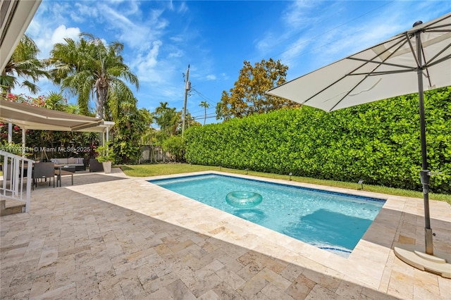 view of pool with a fenced backyard, a fenced in pool, an outdoor hangout area, and a patio area