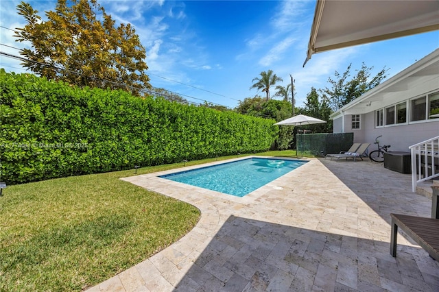 view of pool featuring a fenced in pool, a yard, and a patio area