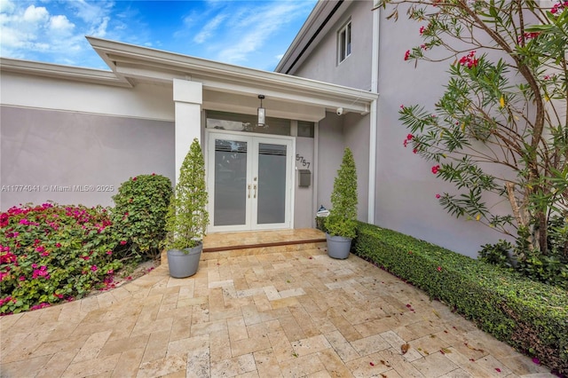 doorway to property with french doors and stucco siding