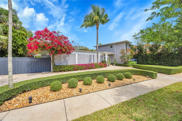 view of front of property featuring stucco siding and fence