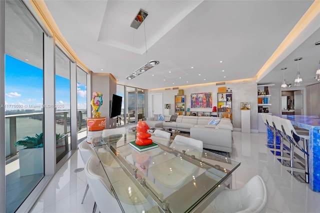 tiled dining space featuring a tray ceiling