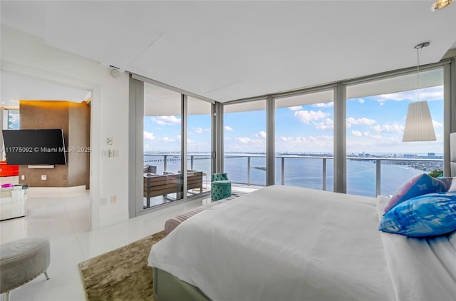 tiled bedroom with a water view, access to outside, a wall of windows, and baseboards
