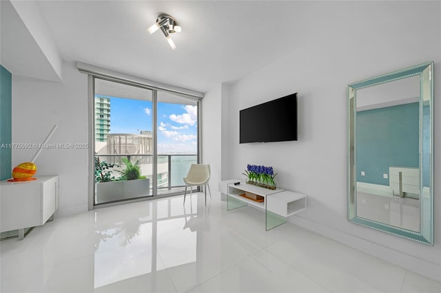 living room featuring expansive windows and tile patterned floors