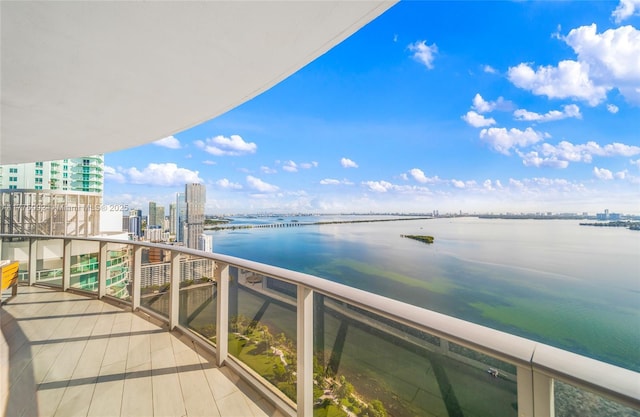 balcony featuring a water view and a view of city