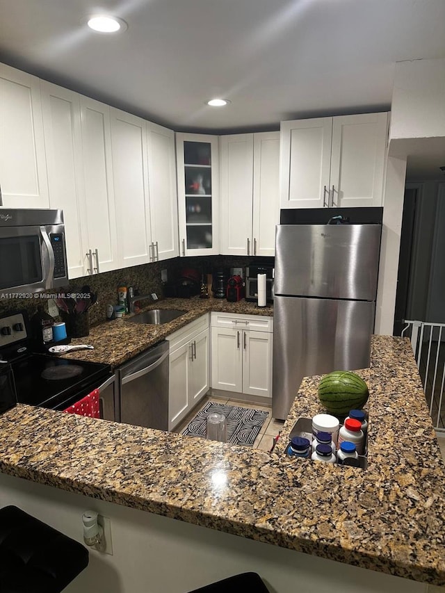 7951 SW 104th Unit 210D, Miami, FL 33156 - kitchen featuring stainless steel appliances, a sink, dark stone countertops, white cabinets, and recessed lighting