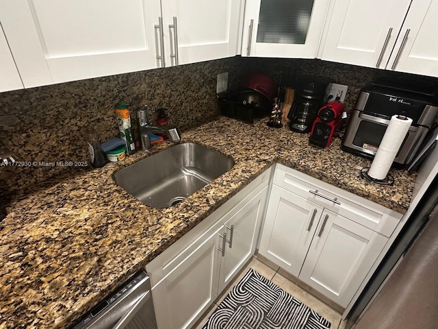 7951 SW 104th Unit 210D, Miami, FL 33156 - kitchen with a sink, white cabinets, dark stone countertops, and decorative backsplash