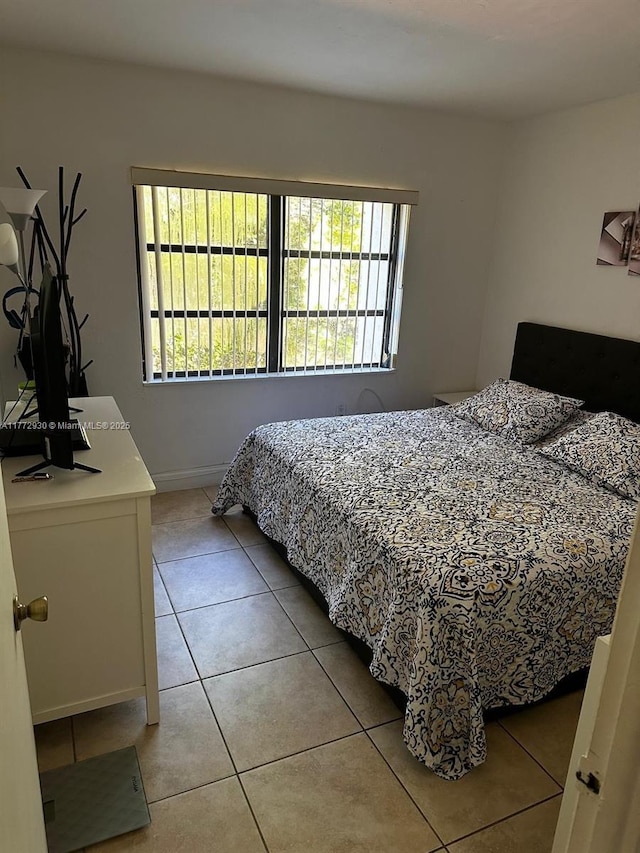 7951 SW 104th Unit 210D, Miami, FL 33156 - bedroom featuring light tile patterned floors and baseboards