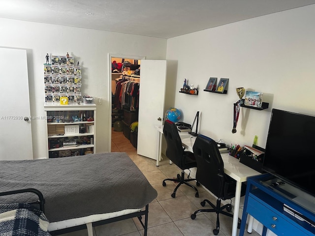 7951 SW 104th Unit 210D, Miami, FL 33156 - bedroom featuring tile patterned flooring, a desk, a closet, and a walk in closet