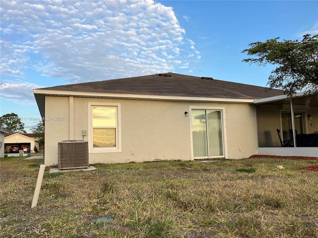 back of house featuring cooling unit and stucco siding