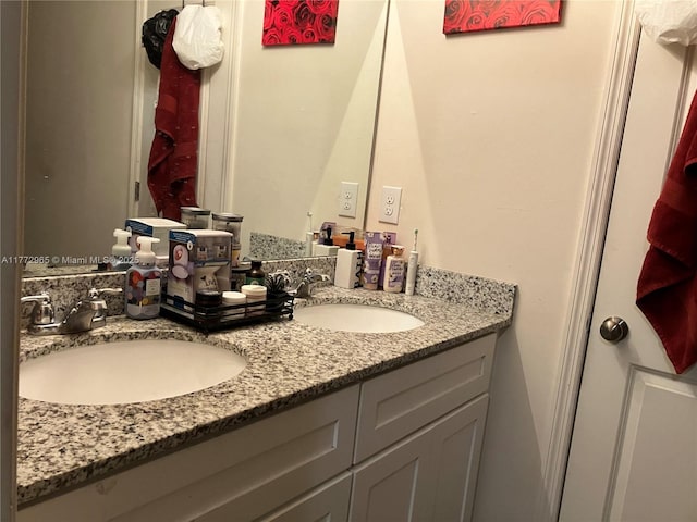 full bathroom featuring double vanity and a sink