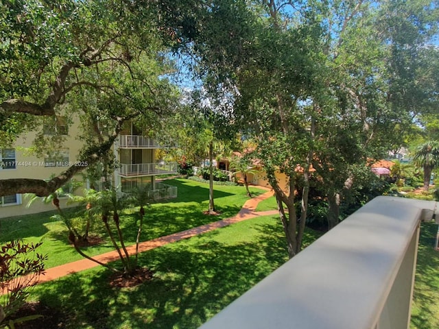 view of home's community with a yard