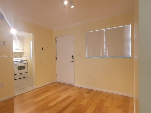 unfurnished room with wood finished floors and baseboards