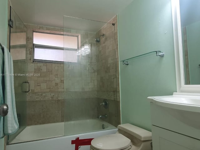 bathroom with toilet, vanity, and shower / bath combination with glass door