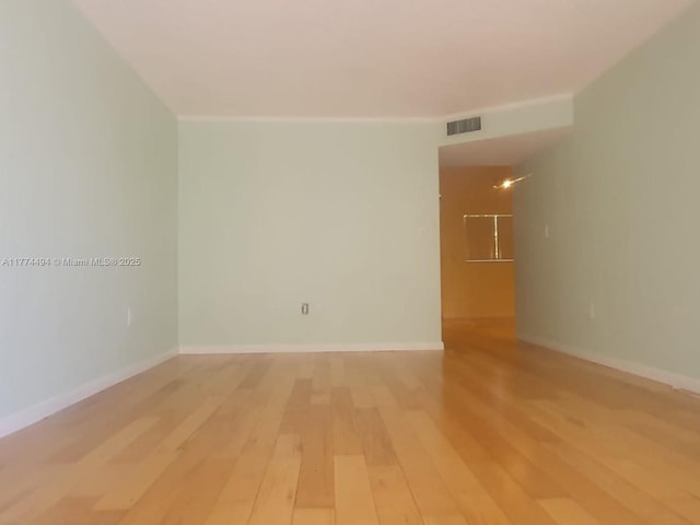 spare room with light wood-type flooring and baseboards