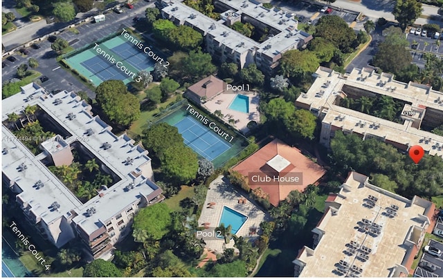 aerial view of property and surrounding area featuring a pool area