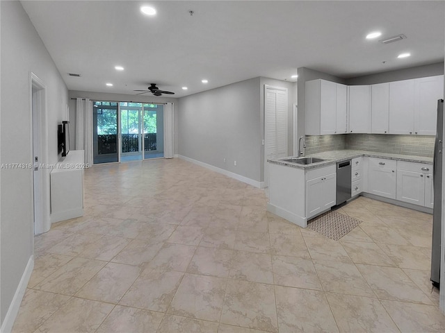 kitchen with ceiling fan, stainless steel dishwasher, recessed lighting, open floor plan, and baseboards