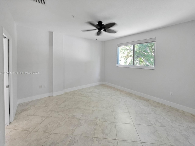 empty room with ceiling fan, baseboards, and visible vents