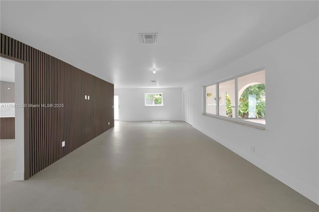 unfurnished room with visible vents and finished concrete flooring
