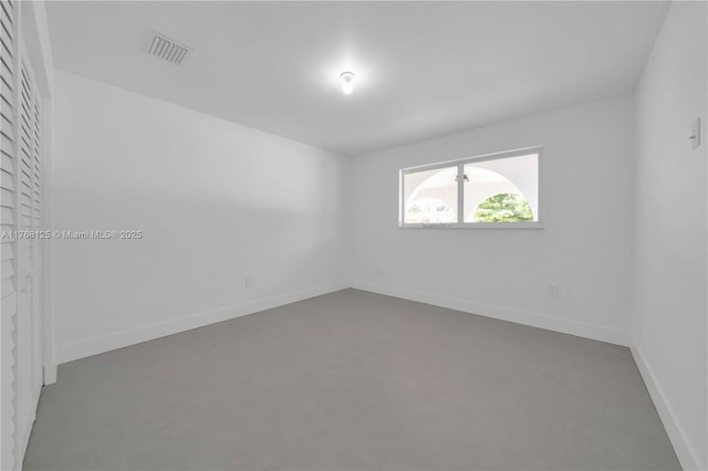 spare room featuring baseboards and visible vents