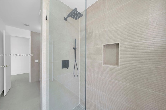 full bath featuring a walk in shower, concrete floors, and visible vents