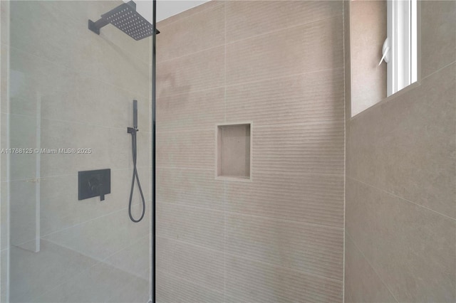 bathroom with tiled shower