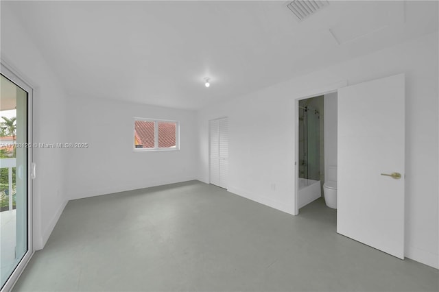 unfurnished room with visible vents, baseboards, and concrete flooring