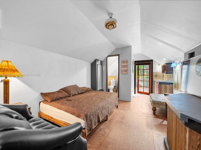 bedroom featuring vaulted ceiling and light wood-style floors