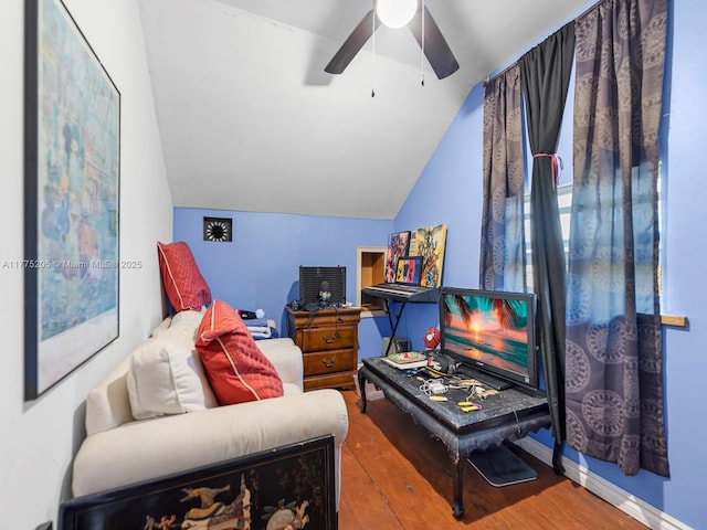 interior space featuring vaulted ceiling, wood finished floors, and ceiling fan