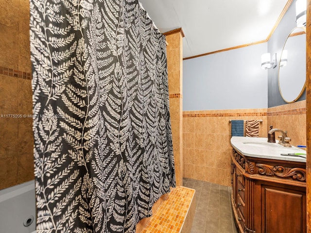 full bathroom with tile walls, crown molding, tile patterned floors, vanity, and wainscoting