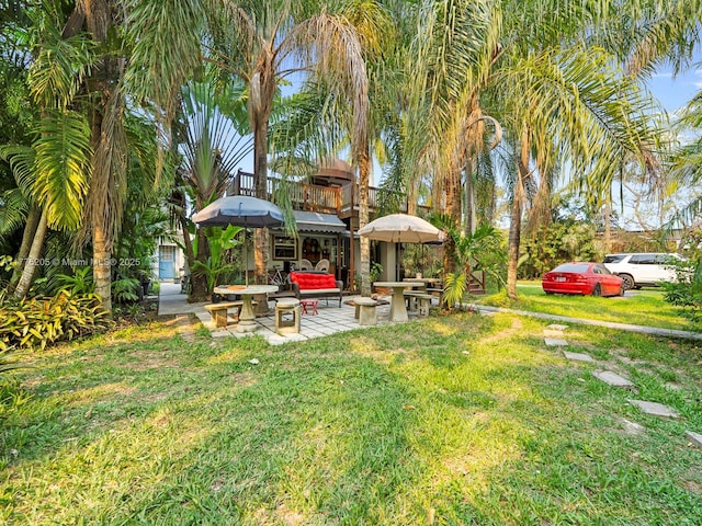 view of yard with a balcony and a patio area