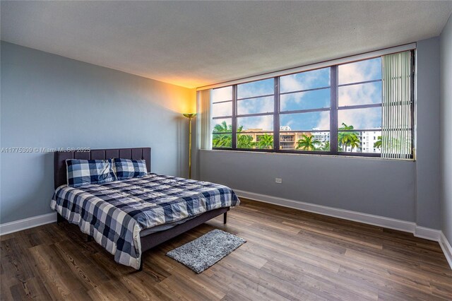 9180 W Bay Harbor Dr Unit 5C, Bay Harbor Islands, FL 33154 - bedroom featuring wood finished floors and baseboards