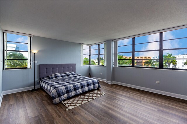9180 W Bay Harbor Dr Unit 5C, Bay Harbor Islands, FL 33154 - bedroom with wood finished floors and baseboards
