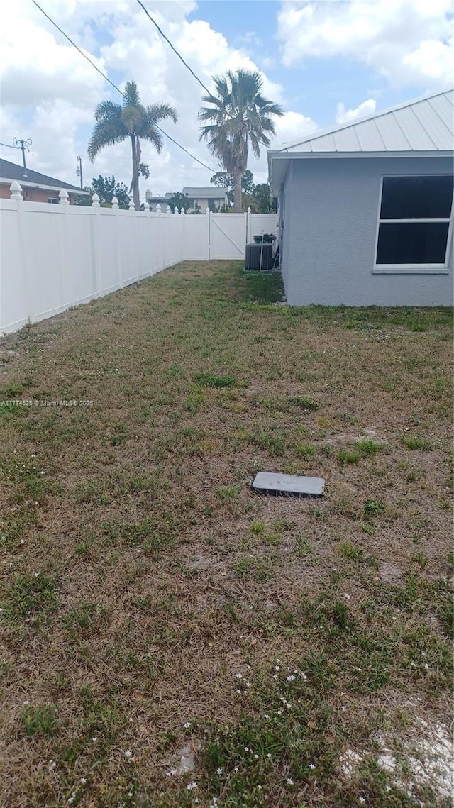 view of yard featuring fence private yard and central AC