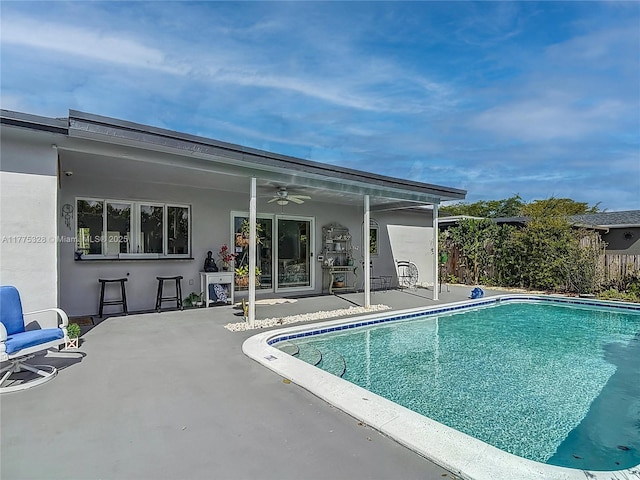 pool featuring a patio, ceiling fan, and fence