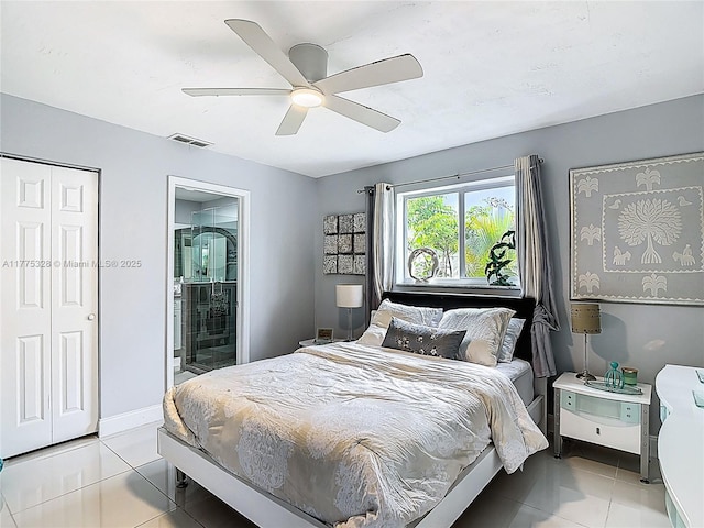 bedroom with a ceiling fan, baseboards, light tile patterned floors, ensuite bathroom, and visible vents